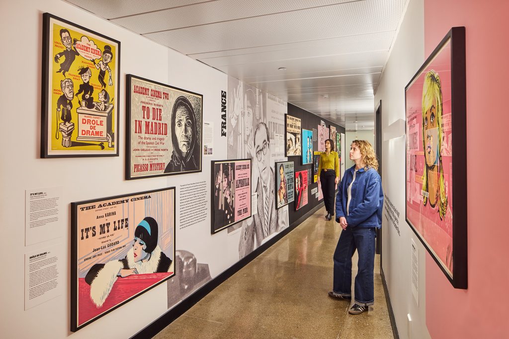 Photo of two people at a poster exhibition.